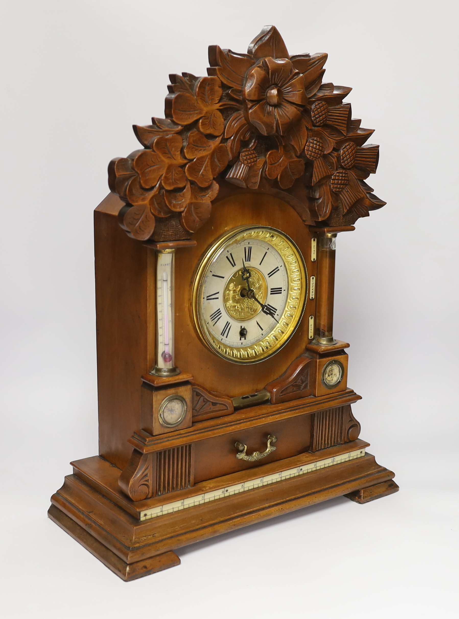 A carved wood clock with barometer, thermometer and compass, 52cm high